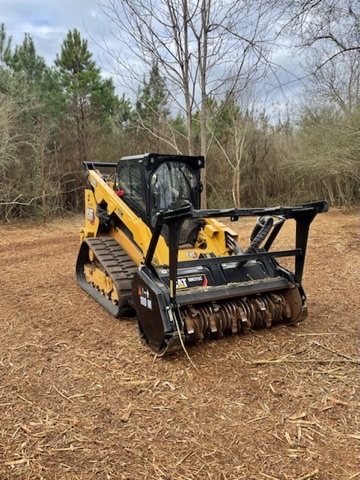 CAT track loader actively clearing wooded land
