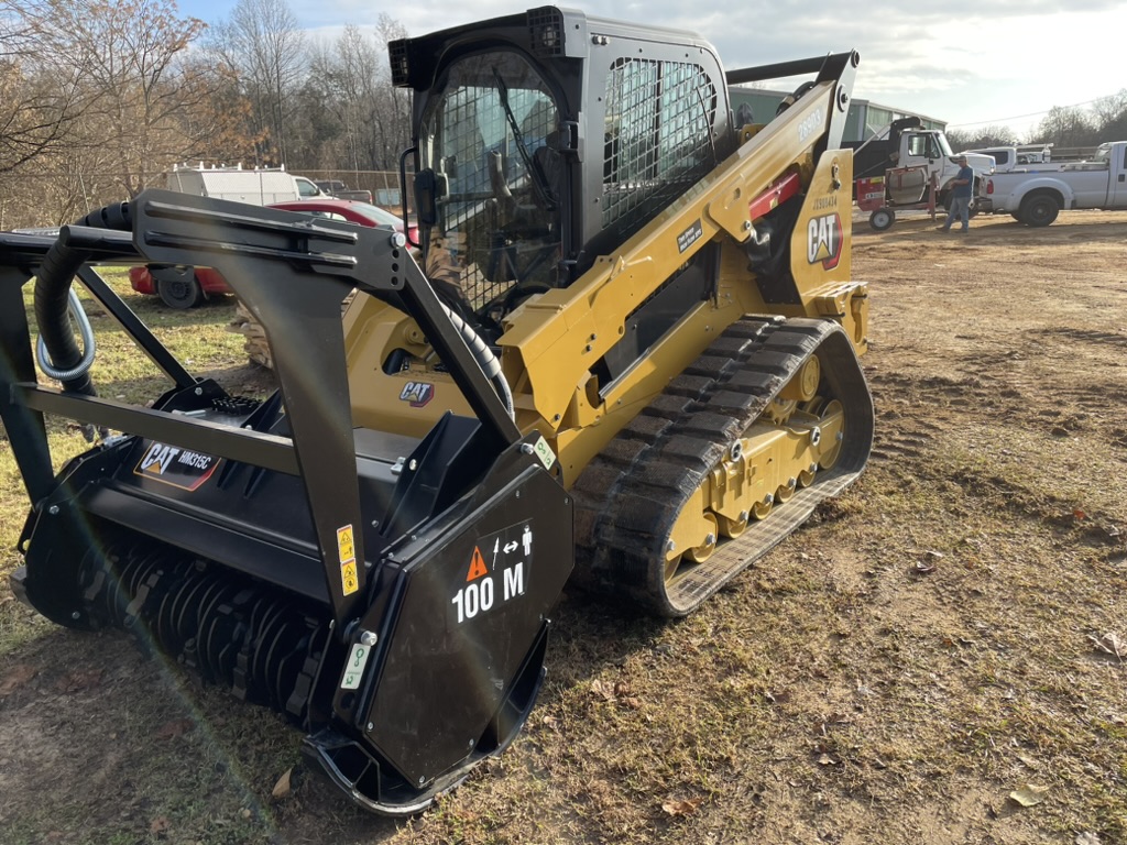 CAT track loader with mulching head attachment in open field